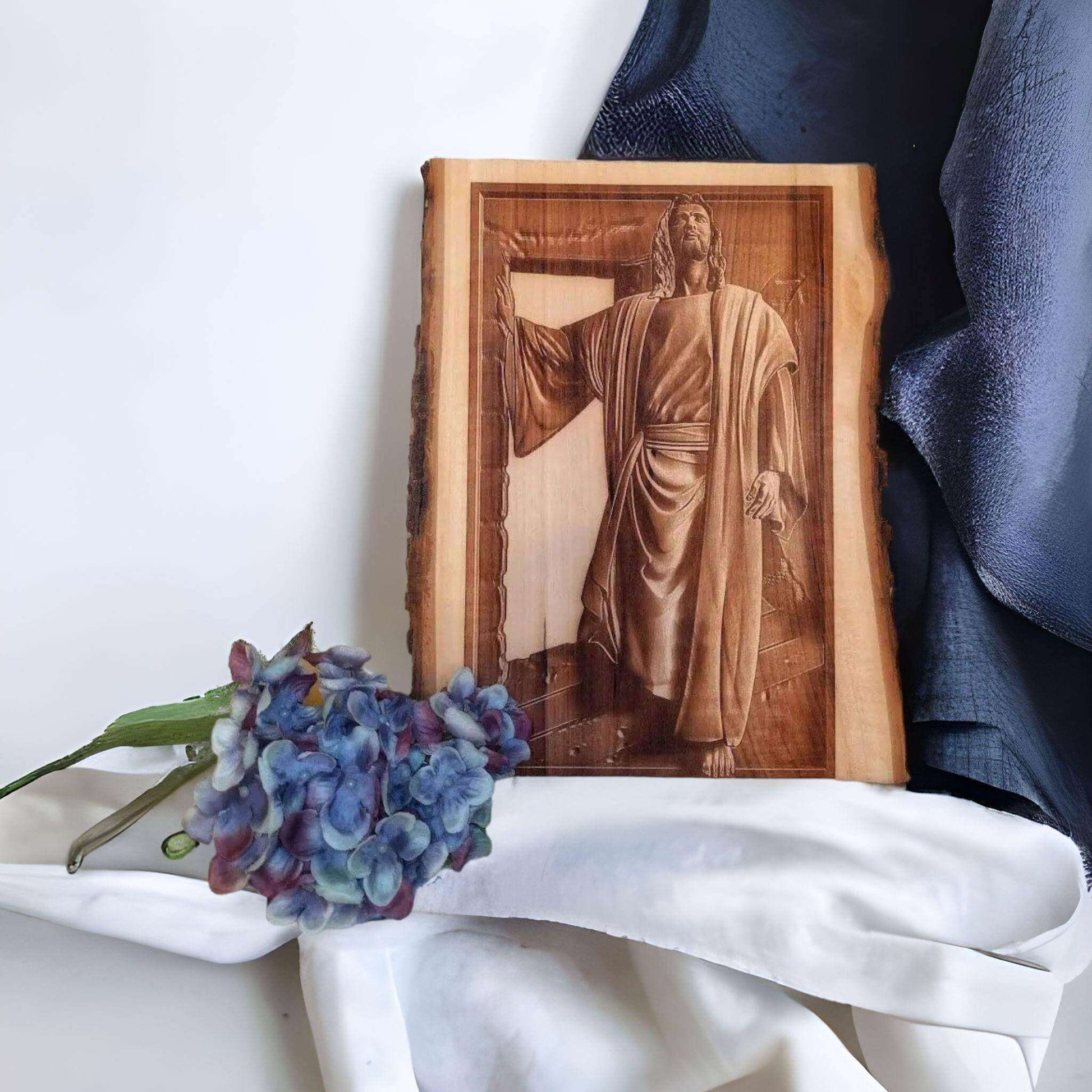 Close-up of 3D Jesus figure emerging from the tomb, crafted in high-detail wood art.