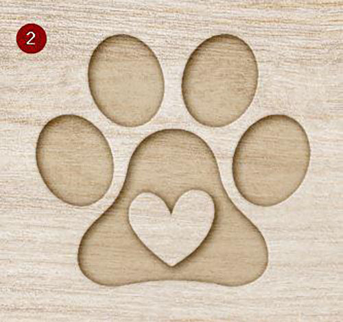 Mock up of a wooden surface with a carved paw print design featuring four oval toe pads and a larger pad with a heart shape in the center