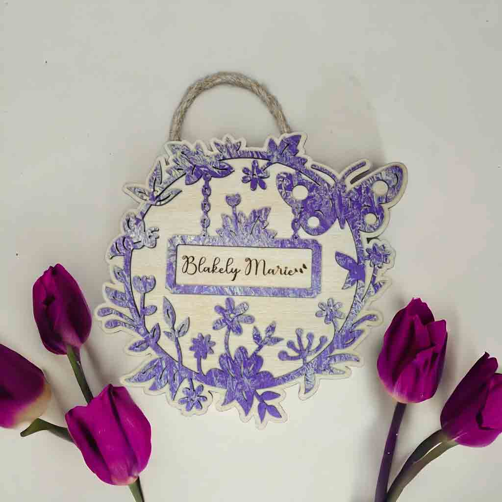 Personalized round nursery door hanger with custom baby name