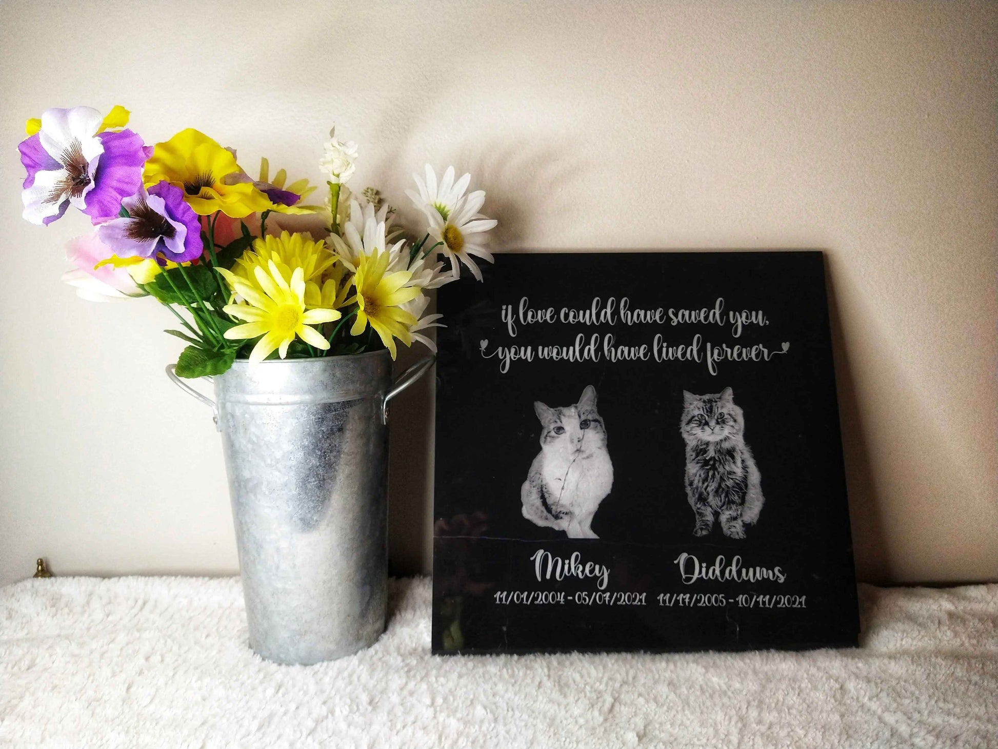 A personalized black marble memorial stone, measuring 12" L x 12" W x 0.375" H, featuring a photo of a beloved pet, their name, dates, and a heartfelt message, creating a timeless and elegant tribute to a cherished companion.